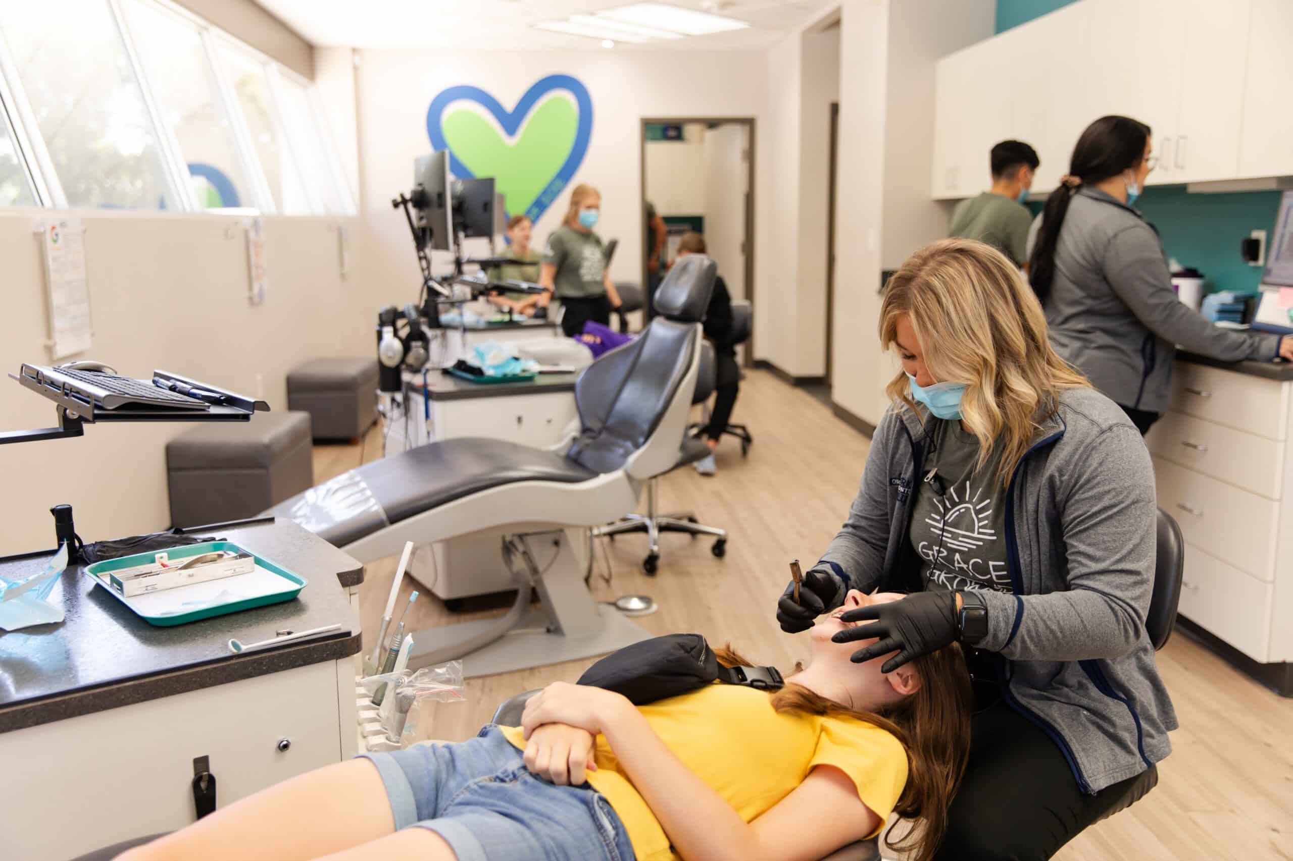 orthodontic staff working with patient